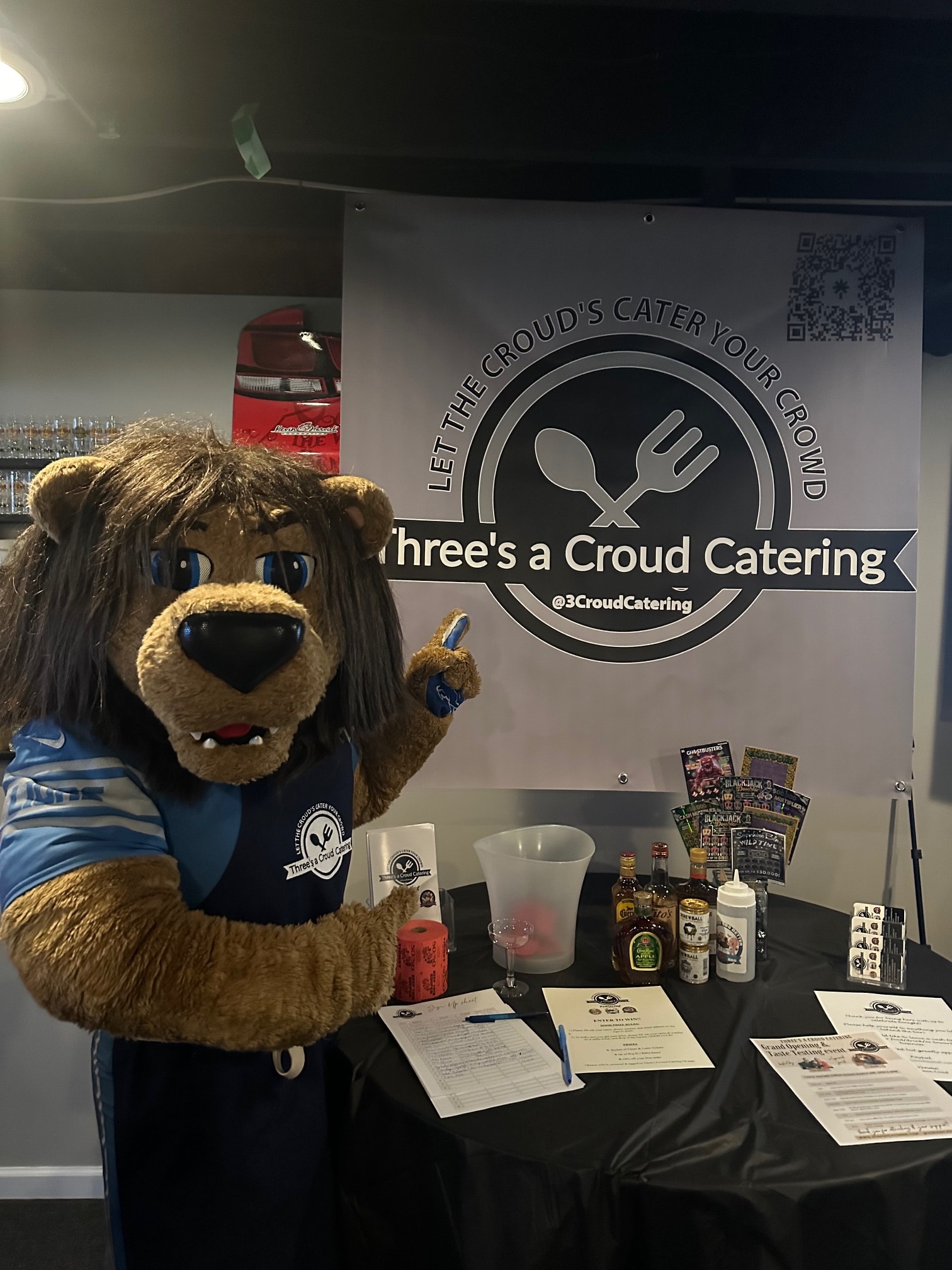 Three's a Croud Catering promotional tasting event with lion mascot