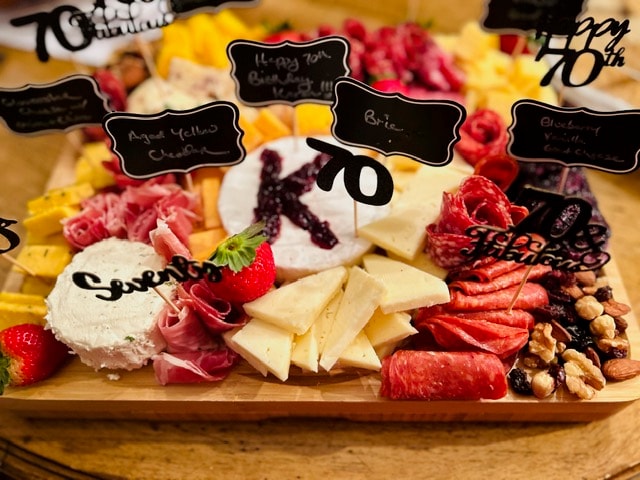 Celebration charcuterie board with cheeses, meats, berries, and crackers