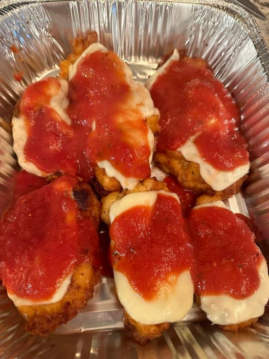 Breaded chicken parmesan topped with melted cheese and tomato sauce